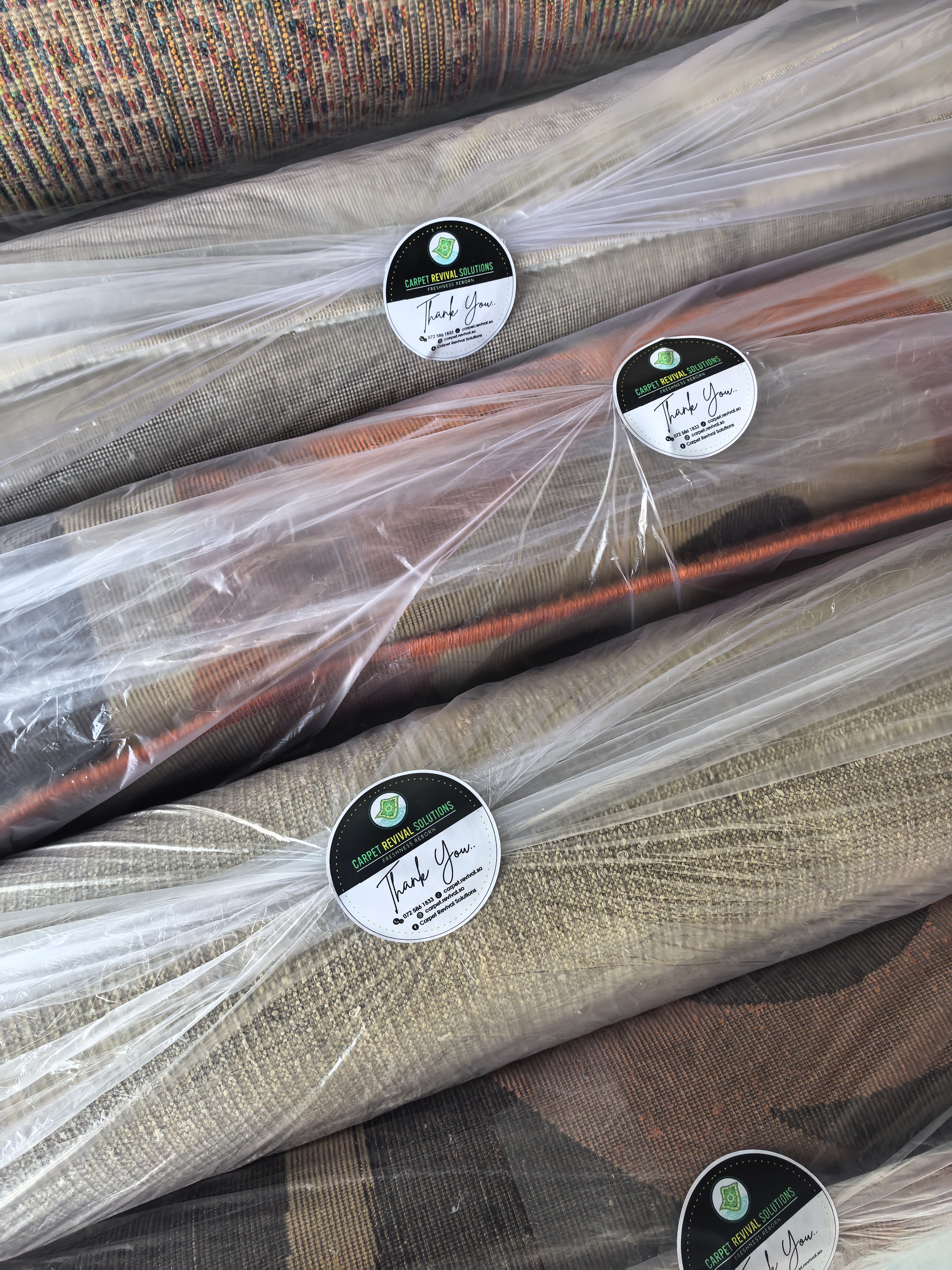 Professionally cleaned and plastic-wrapped area rugs ready for delivery in Pretoria.